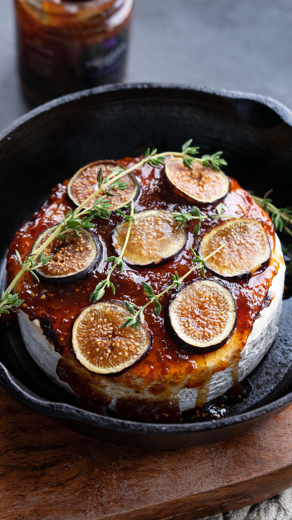 Baked brie in a cast iron drizzled with fig spread