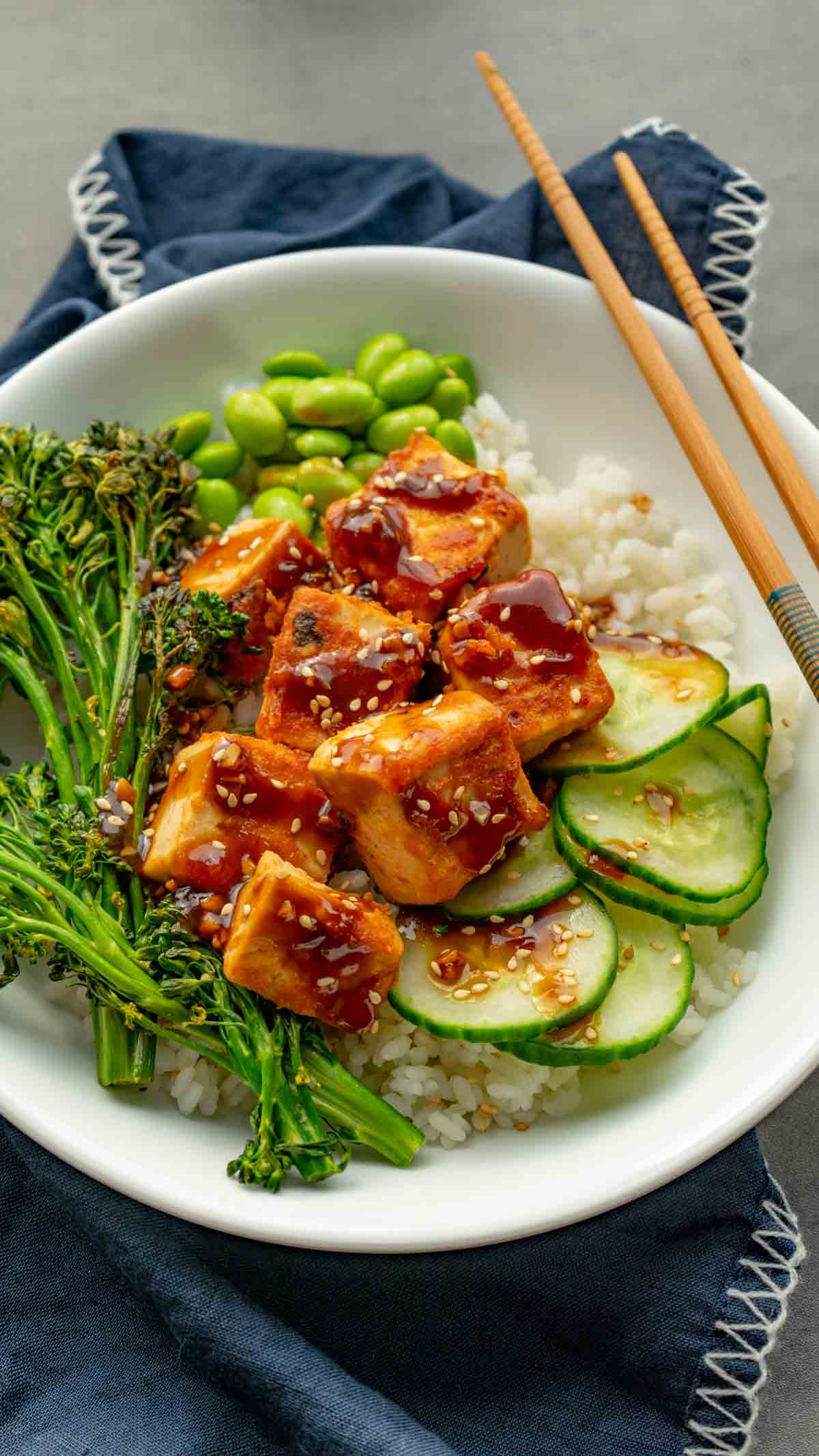 Tofu salmon rice bowl served with edamame, cucumber, ands broccoli